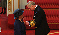 Image of Alison Mihail receiving her MBE from the Prince of Wales